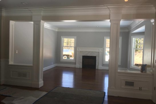 Finished residential living room with custom trim and hardwood flooring