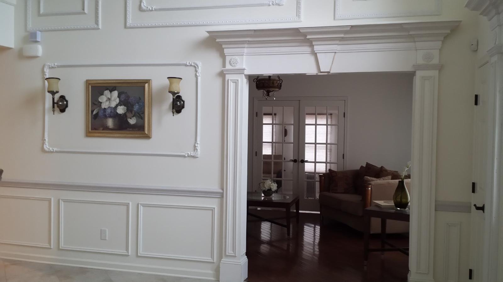 Residential interior with decorative wall molding and custom doorway trim
